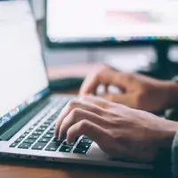 Person typing on a laptop computer